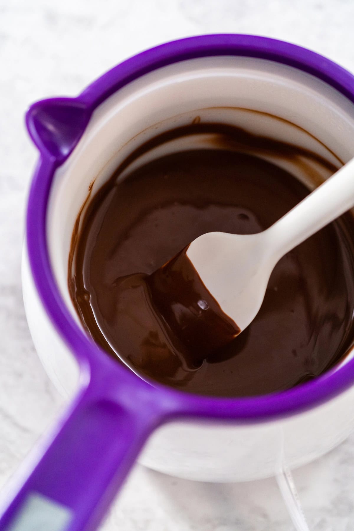A melting pot filled with melted chocolate.