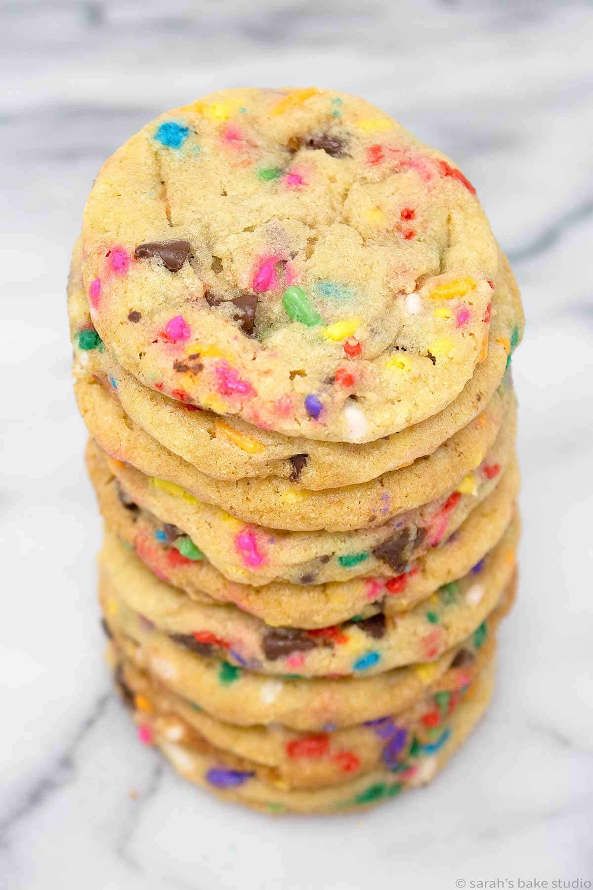 an overhead view of chocolate chip cake batter cookies stacked in a tower