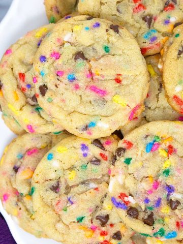 an up close look at chocolate chip cake batter cookies on a plate