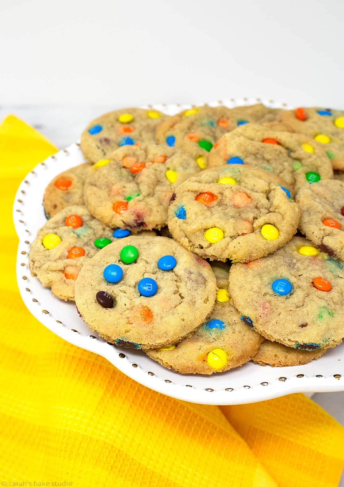 A stacked cake plate of M&M cookies.
