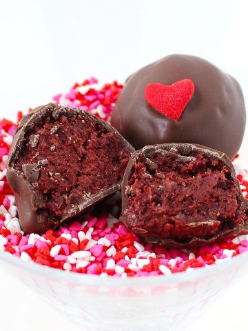 a red velvet oreo truffle cut in half so you can see the inside.