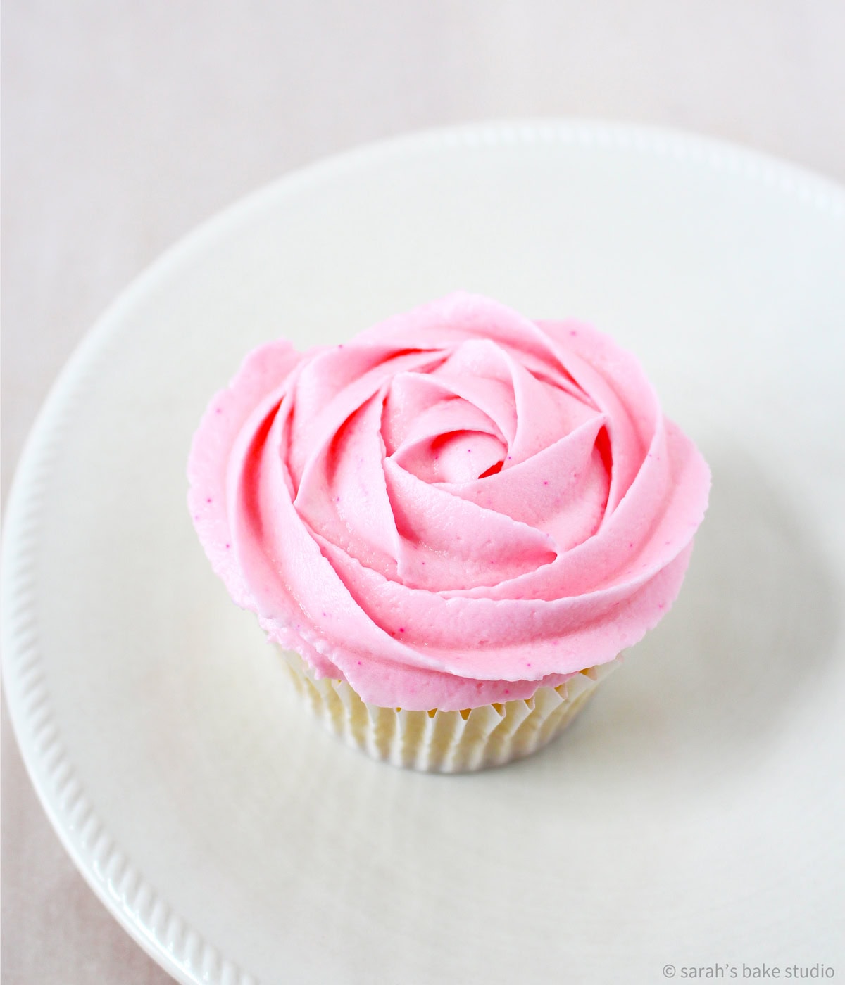 A pink rose frosted cupcake.
