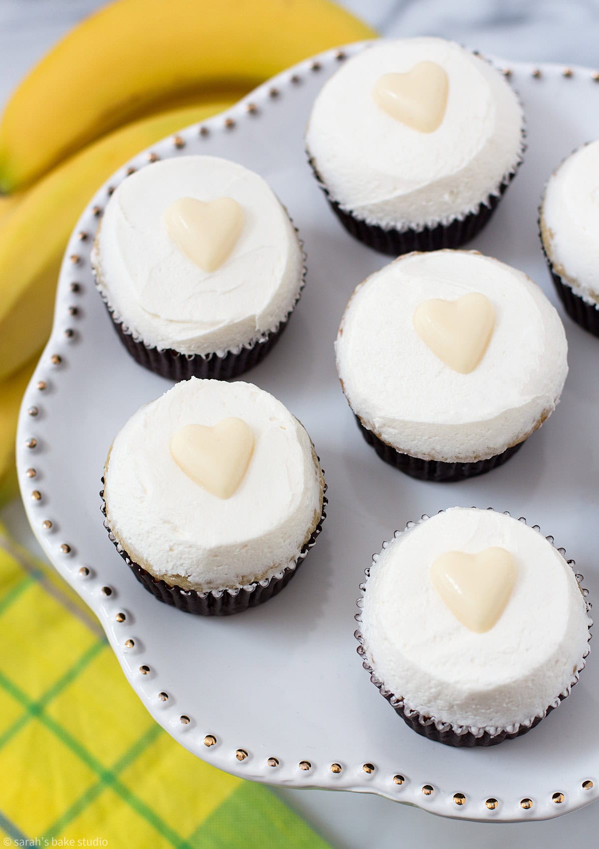 A cake plate with Very Banana Cupcakes.