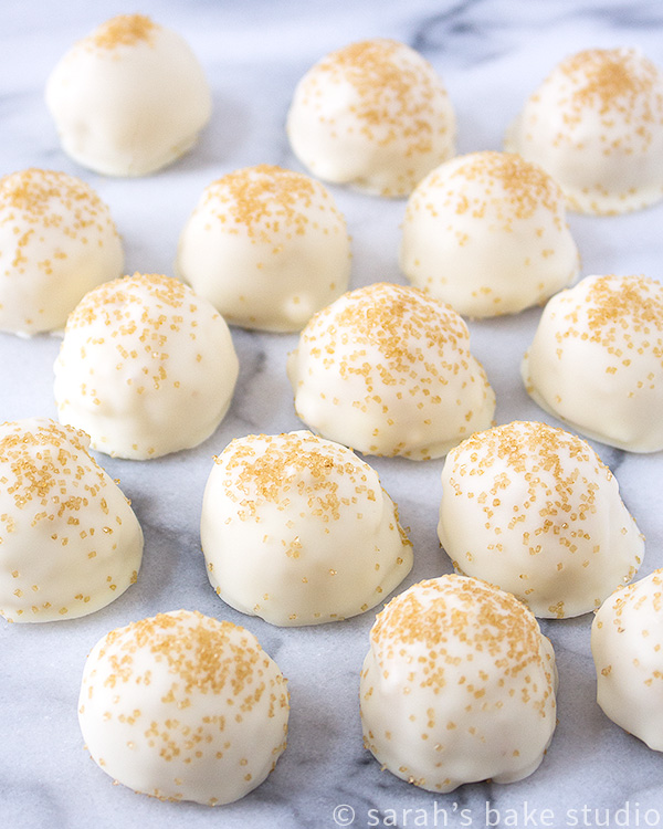 Golden Oreo Truffles – crushed Golden Oreo cookies mixed with cream cheese, scooped, and dipped into beautiful melted Ghirardelli white chocolate; pure Oreo truffle bliss.