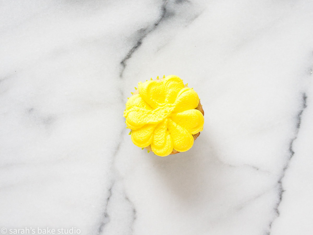 a mini cupcake with buttecream daisy petals