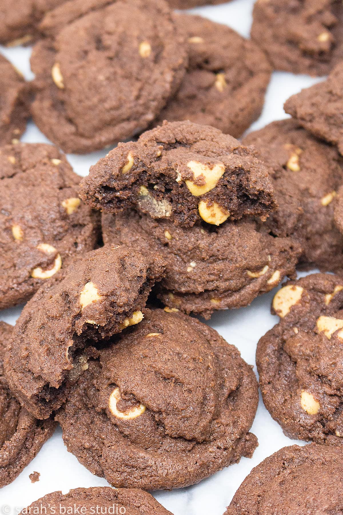 Chocolate Peanut Butter Chip Cookies up-close with one broken in half.
