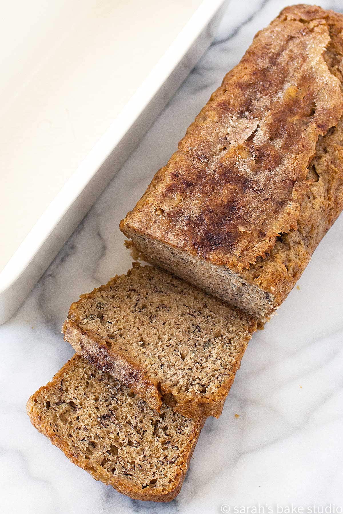 Banana Walnut Bread loaf with sliced bread pieces.