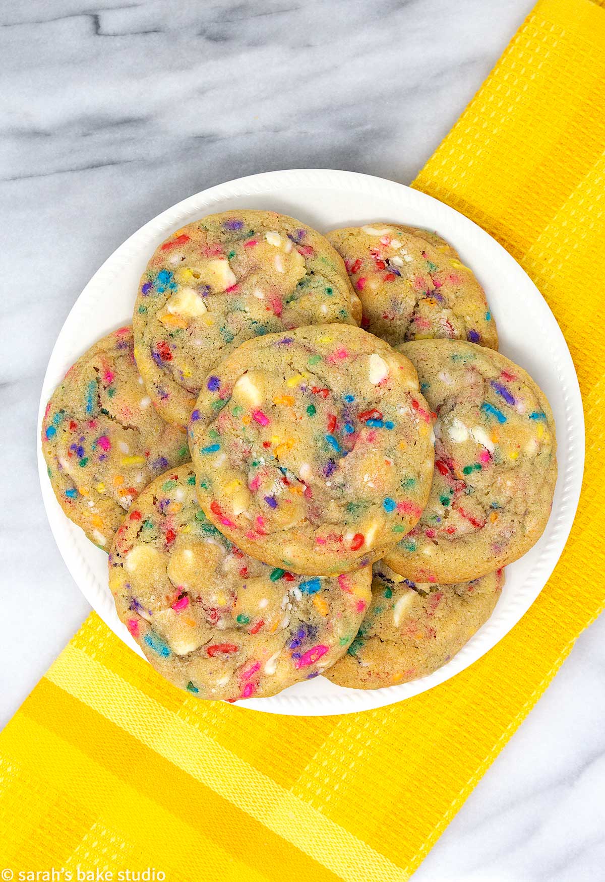 white chocolate confetti cookies stacked on a plate