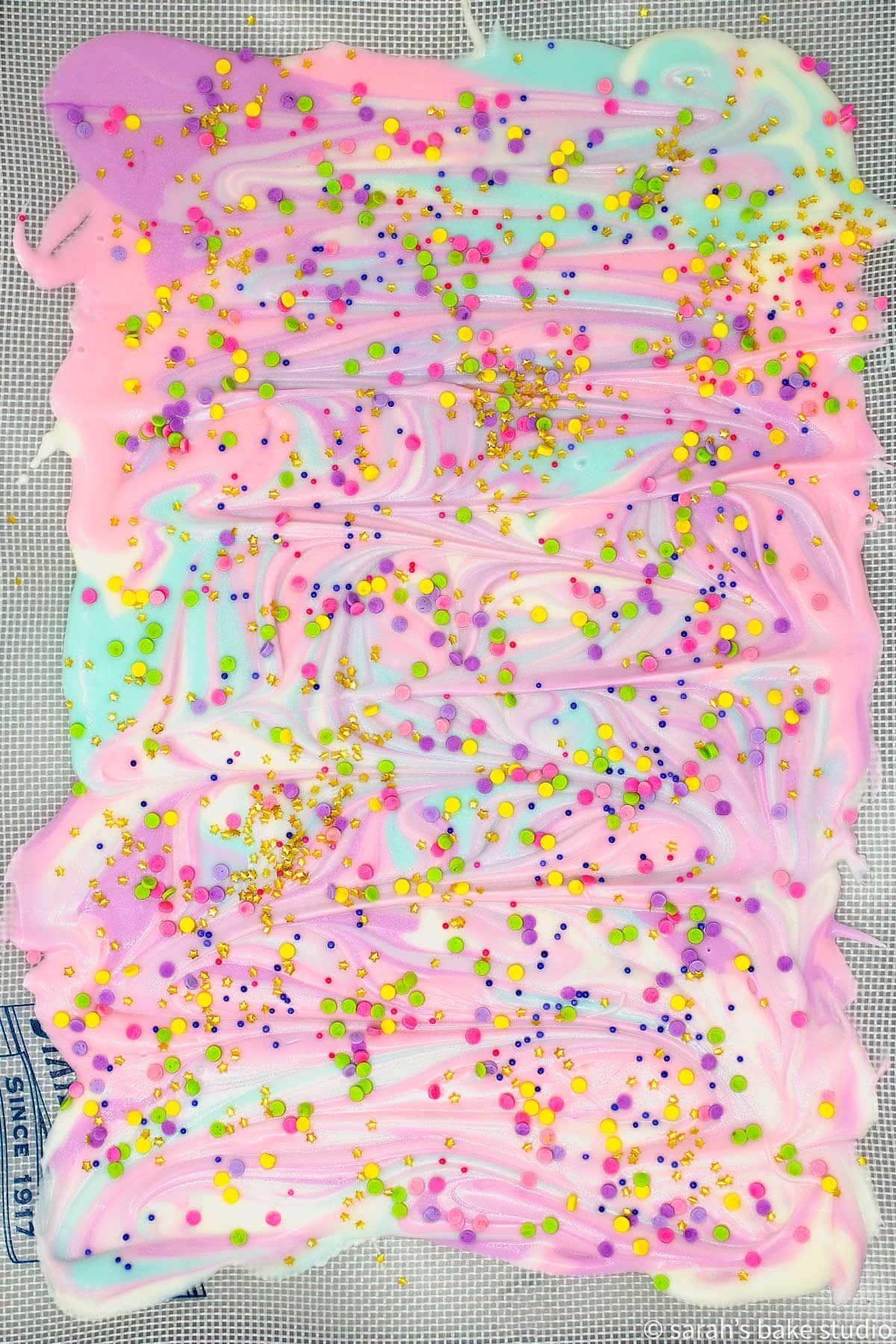 White Chocolate Unicorn Bark on a silicone mat before it's broken into pieces.