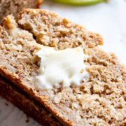 a slice of apple bread with a slab of butter on it.