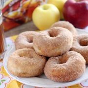 a plate stacked with apple cider donuts.