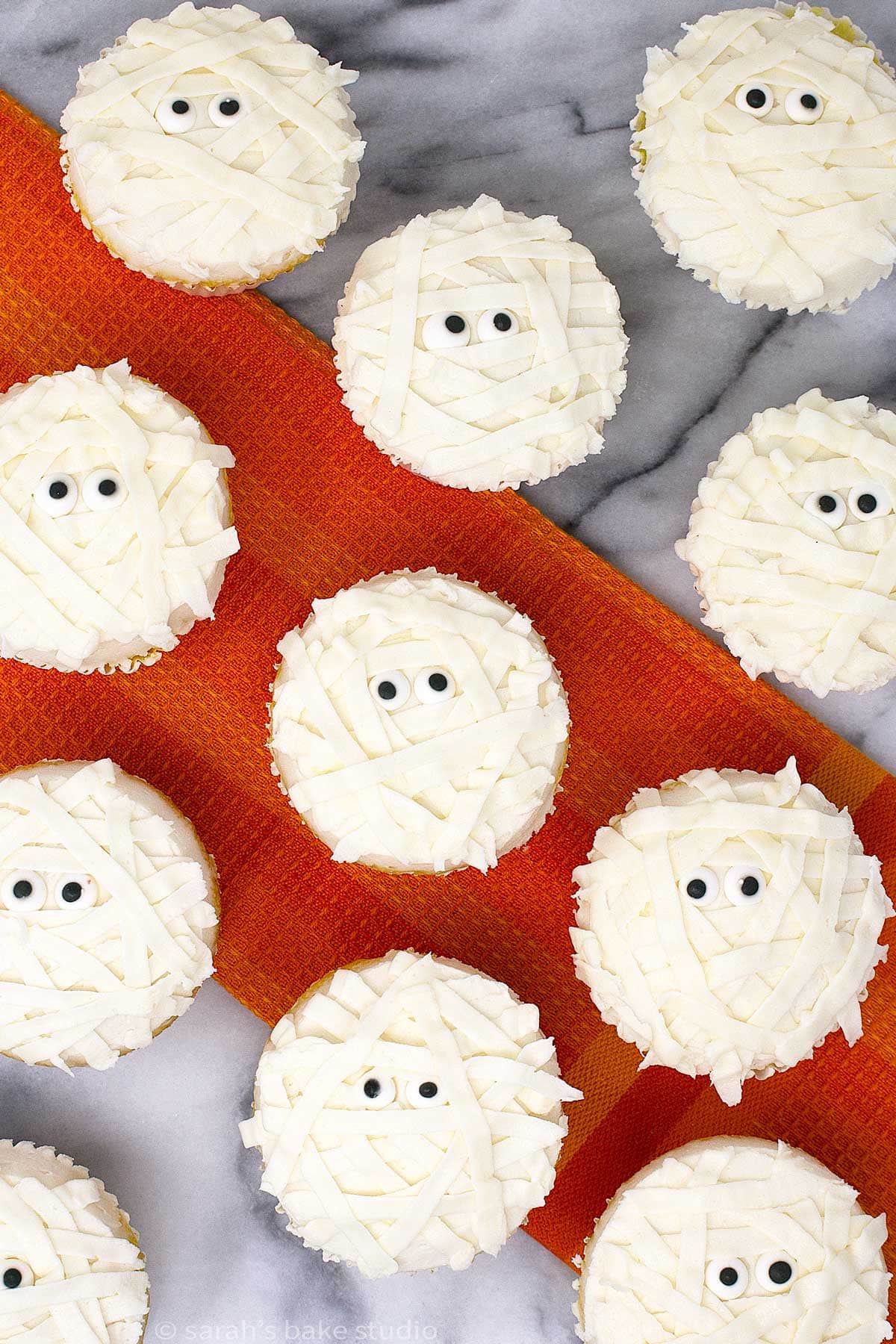 a flatlay of halloween mummy cupcakes.