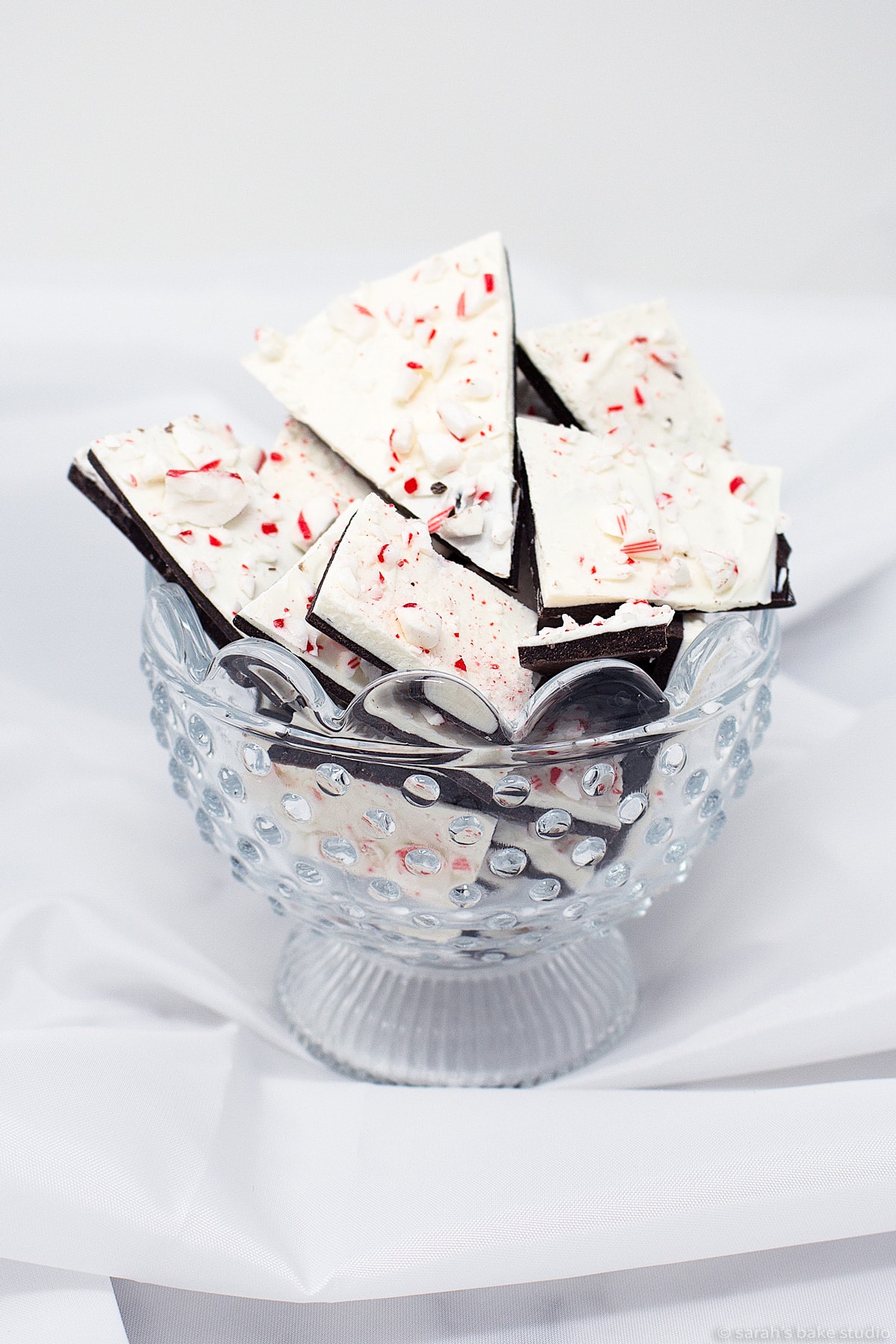 a glass bowl filled with homemade peppermint chocolate bark.
