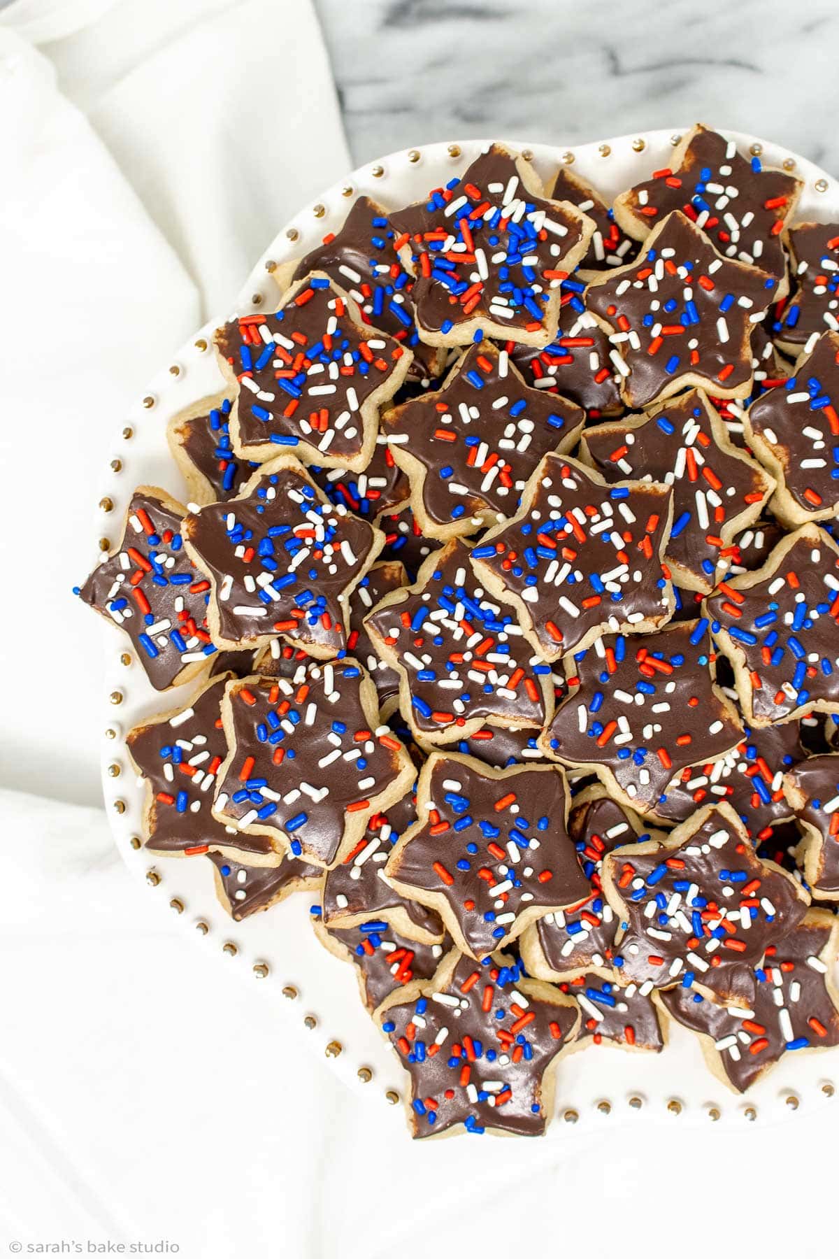 an up-close stack of patriotic star sugar cookies on a plate
