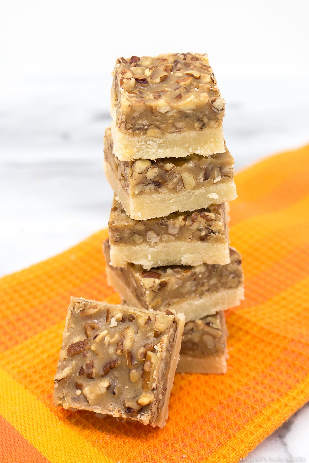 pecan pie bars stacked into a tower.