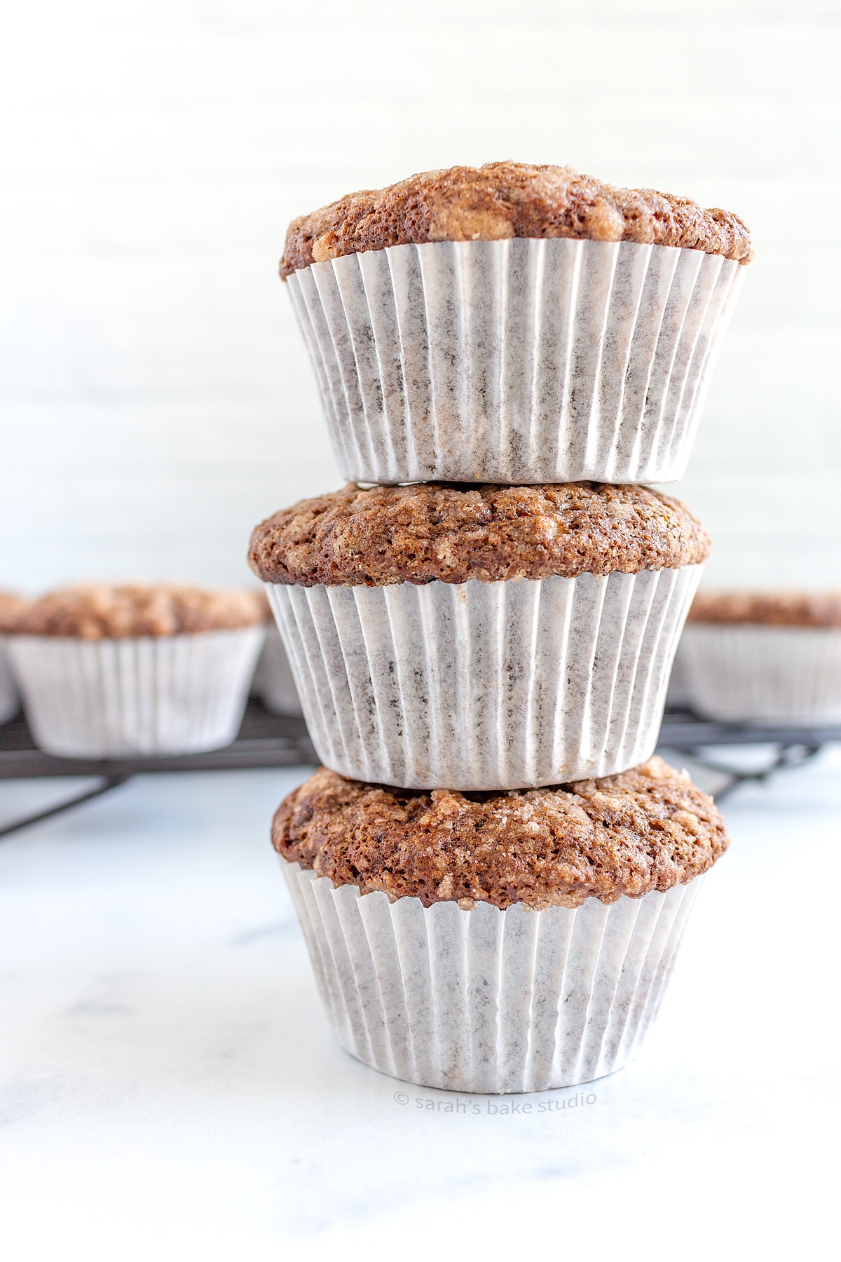 A stacked tower of three Double Chocolate Banana Muffins.