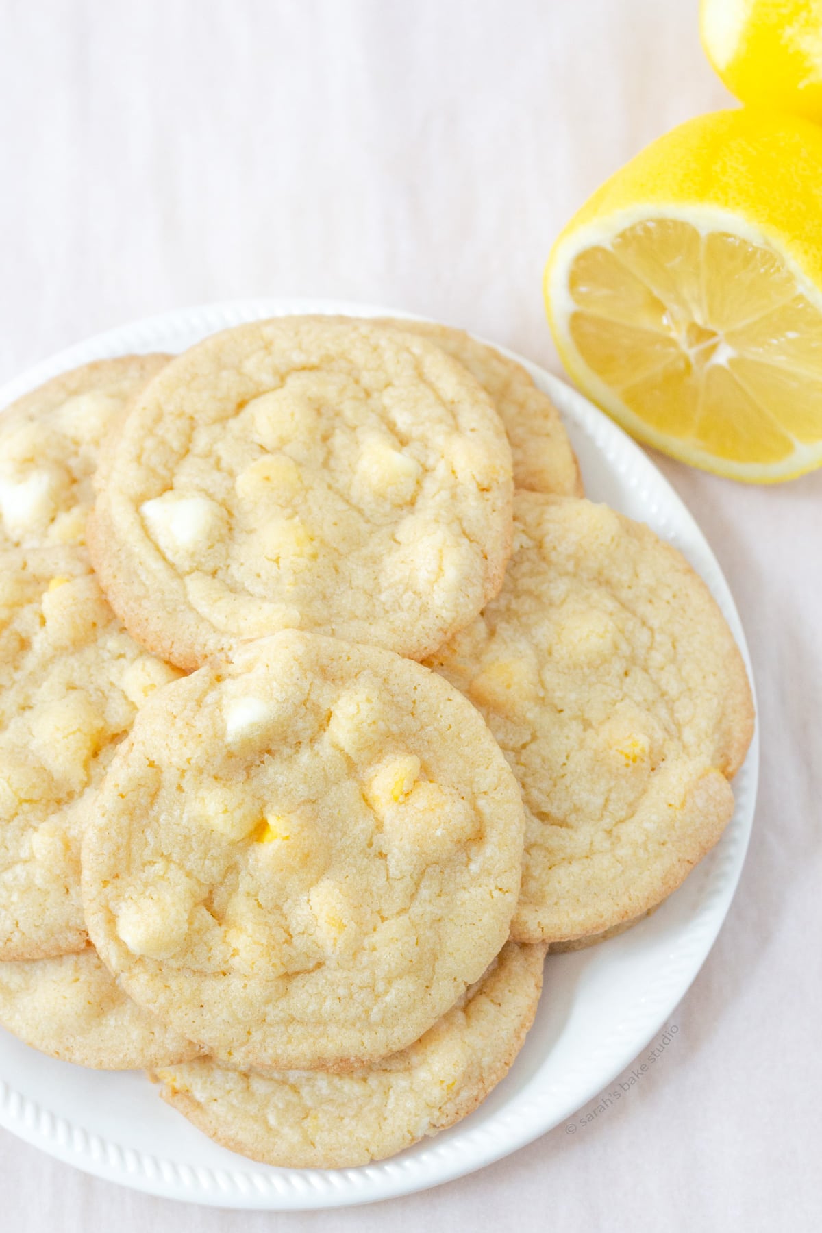 A plate stacked with Lemon White Chocolate Chip Cookies.
